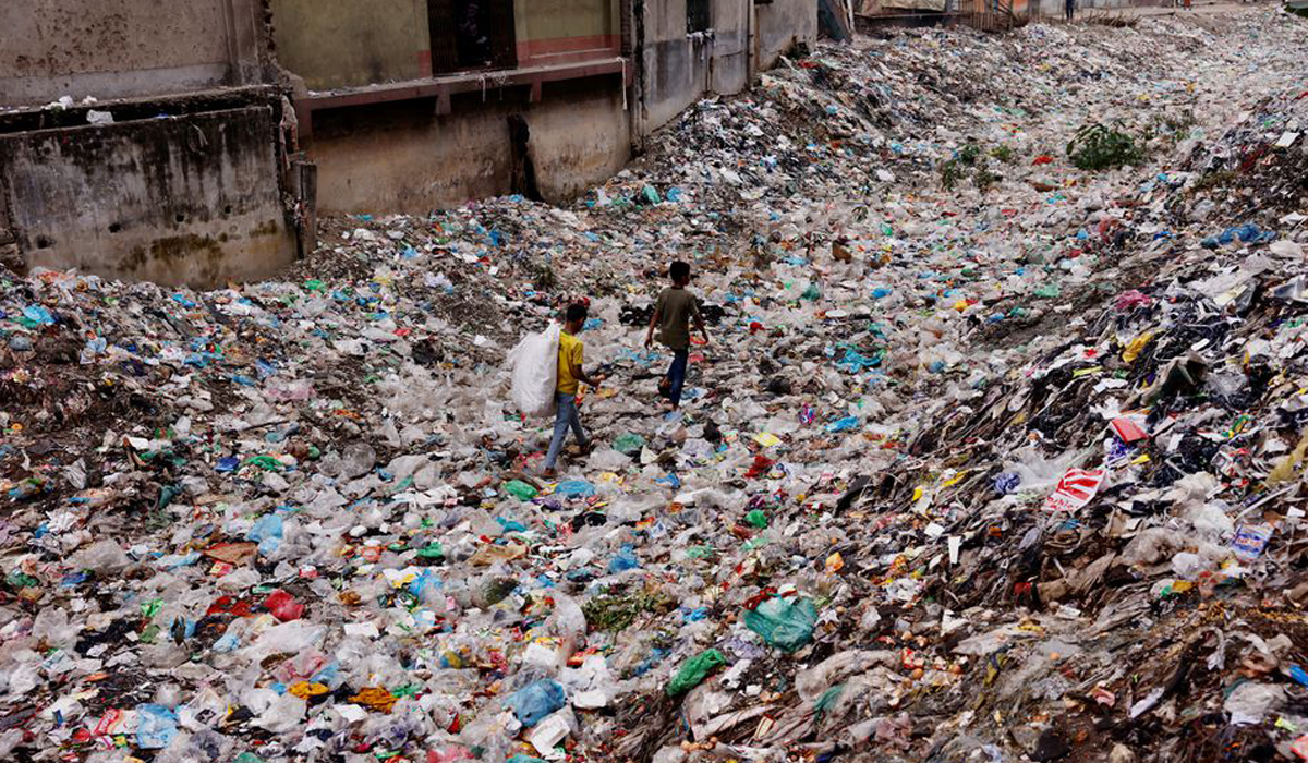 Children walk over a polluted area in Bangladesh